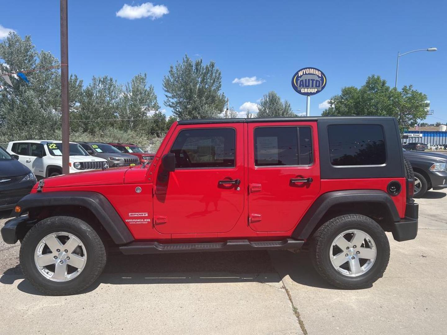 2010 red Jeep Wrangler Unlimited Sport (1J4BA3H11AL) with an V6, 3.8L engine, Manual transmission, located at 3030 CY Ave, Casper, WY, 82604, (307) 265-3830, 42.827816, -106.357483 - Photo#0