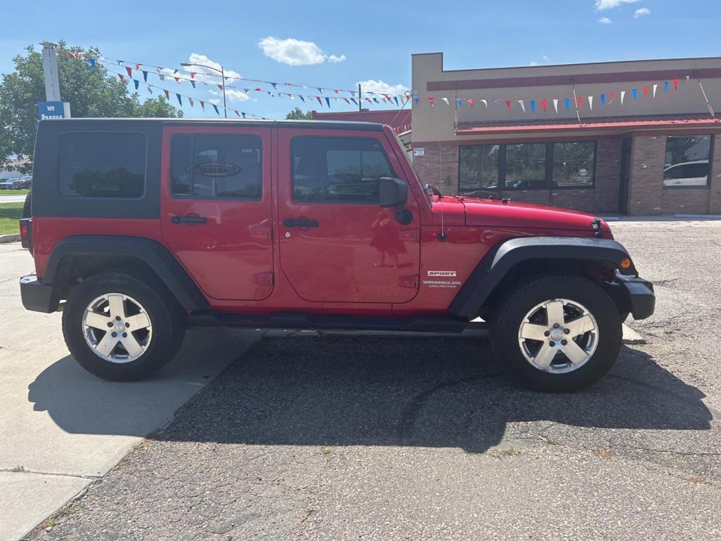 2010 red Jeep Wrangler Unlimited Sport (1J4BA3H11AL) with an V6, 3.8L engine, Manual transmission, located at 3030 CY Ave, Casper, WY, 82604, (307) 265-3830, 42.827816, -106.357483 - Photo#4