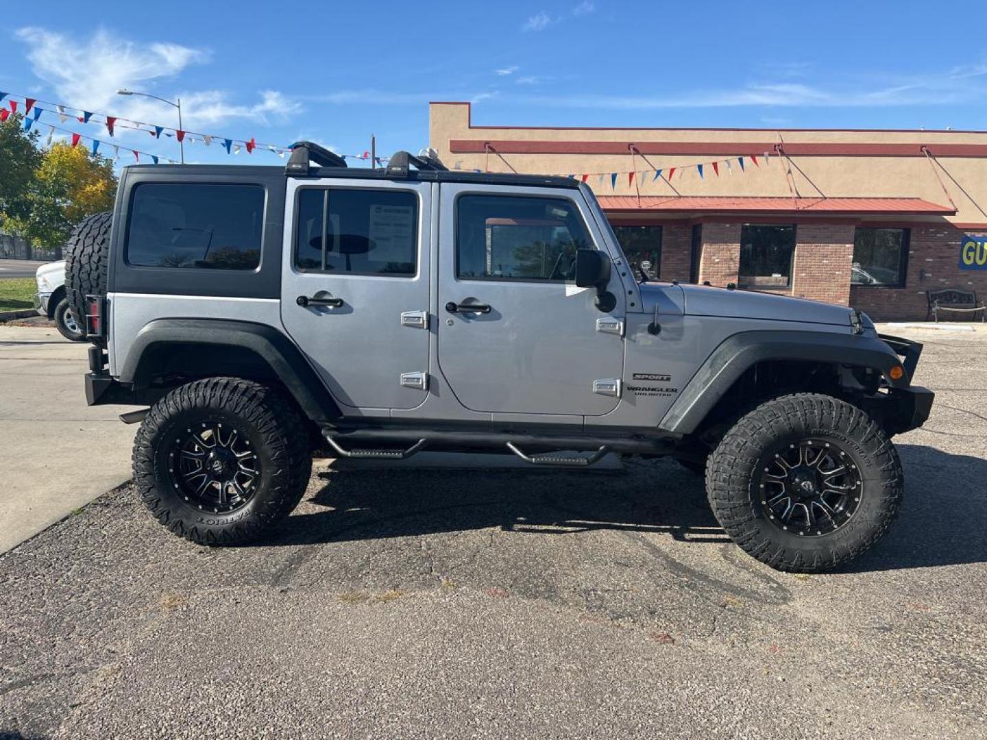 2015 silver Jeep Wrangler Unlimited Sport (1C4BJWDG4FL) with an V6, 3.6L engine, Automatic transmission, located at 3030 CY Ave, Casper, WY, 82604, (307) 265-3830, 42.827816, -106.357483 - For sale at our dealership is a robust and reliable 2015 Jeep Wrangler Unlimited Sport, perfect for those who crave adventure and off-road capability. This iconic SUV is equipped with a powerful V6, 3.6L engine and a dependable 4WD system, providing the performance you need for both city driving and - Photo#4